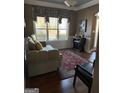 Living room featuring hardwood floors, sofa, and wine rack at 100 Harmony Ct, Dallas, GA 30157