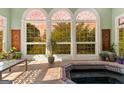 Sunroom with a hot tub and many windows at 1477 Highway 85 Connector, Brooks, GA 30205