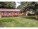 Beautiful brick home with manicured landscaping and lush green lawn at 3170 Ebenezer Rd, Marietta, GA 30066