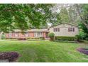 Charming brick home with a lush green lawn, manicured hedges, and large trees at 3170 Ebenezer Rd, Marietta, GA 30066