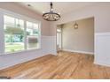 Bright dining area with hardwood floors and a view of the entry at 65 Oakhurst Trl, Sharpsburg, GA 30277