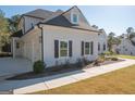 A side view of the house showing a three car garage and a walkway at 20 Platinum Rdg, Sharpsburg, GA 30277