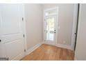 Bright laundry area with hardwood floors and access to the backyard at 20 Platinum Rdg, Sharpsburg, GA 30277