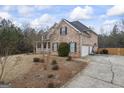 Brick house with two-car garage and inviting front porch, surrounded by trees at 25 Abelia Dr, Covington, GA 30014