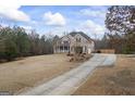 Large brick home with a long driveway and well-maintained lawn at 25 Abelia Dr, Covington, GA 30014