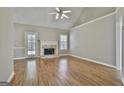 Bright living room featuring a fireplace, wood floors and a ceiling fan at 110 Cloverwood Dr, Fayetteville, GA 30215