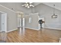 Open floor plan showing the living room with wood floors and the adjacent kitchen at 110 Cloverwood Dr, Fayetteville, GA 30215