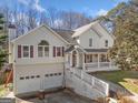 Classic home featuring a two-car garage, front porch, and driveway at 232 Taylors Farm Dr, Canton, GA 30115
