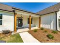 Front porch with wooden columns and landscaping at 69 Oakhurst Trl, Sharpsburg, GA 30277