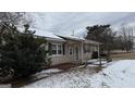 Ranch home with covered porch and snow-covered yard at 1597 Highway 92 S, Fayetteville, GA 30215