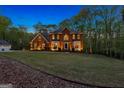 Brick home with a large, grassy front yard and attached garage at 150 S Kite Lake Rd, Fayetteville, GA 30214