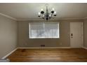 Simple dining room with hardwood floors and chandelier at 730 N Carter Dr, Jonesboro, GA 30236