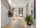 The bright foyer features modern staircase and accent lighting, creating a welcoming entry at 200 Simonton Rd, Lawrenceville, GA 30046