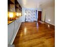 Living room with hardwood floors and built-in shelving at 485 Evergreen Dr, Forest Park, GA 30297