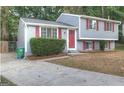 Two-story house with gray siding, red shutters, and a red door at 2036 Countydown Ln, Stone Mountain, GA 30088