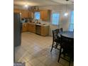 Kitchen with light wood cabinets, tile floor, and a dining area at 2658 Deann Dr, Ellenwood, GA 30294