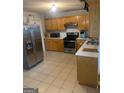 Kitchen with stainless steel appliances and light wood cabinets at 2658 Deann Dr, Ellenwood, GA 30294