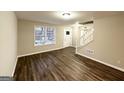 Living room featuring hardwood floors and a staircase at 3880 Springleaf Ct, Stone Mountain, GA 30083