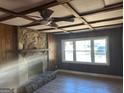 Living room with stone fireplace and hardwood floors at 285 Queen Helen Ln, Jonesboro, GA 30236