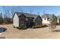 Two-story house with a two-car garage and landscaping at 160 Traditions Ln, Hampton, GA 30228