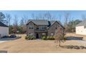 Two-story house with a covered porch and landscaping at 160 Traditions Ln, Hampton, GA 30228