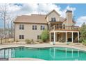 Beautiful backyard with a large swimming pool, deck, and covered patio, perfect for entertaining at 108 Turnberry Trce, Sharpsburg, GA 30277
