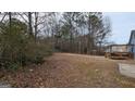 Large backyard with mature trees and a deck at 6627 Coventry Pt, Austell, GA 30168