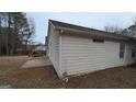Tan house exterior with a deck and backyard at 6627 Coventry Pt, Austell, GA 30168