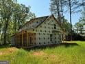 New construction with wrap-around porch detail, siding not yet installed, in wooded setting at 150 Asa Moseley Rd, Mcdonough, GA 30252