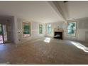 Bright living room with a fireplace and multiple windows, offering views of the surrounding landscape at 150 Asa Moseley Rd, Mcdonough, GA 30252