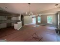 Open living area with neutral walls and wood flooring leading into the kitchen at 150 Asa Moseley Rd, Mcdonough, GA 30252