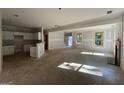 Open-concept living space with abundant natural light, fireplace, and seamless flow to the kitchen area at 150 Asa Moseley Rd, Mcdonough, GA 30252