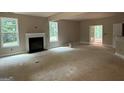 Bright living room with large windows and a cozy fireplace ready to be finished at 150 Asa Moseley Rd, Mcdonough, GA 30252
