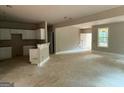 Spacious living room with an open floor plan and view into the kitchen space at 150 Asa Moseley Rd, Mcdonough, GA 30252