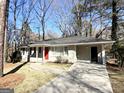 House exterior showcasing a red front door and a paved driveway at 3006 Remington St, East Point, GA 30344