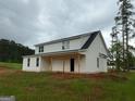Two-story home showcasing a spacious porch and light-colored siding, set in a developing lot at 136 Asa Moseley Rd, Mcdonough, GA 30252