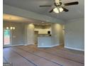 Open-concept living room flows seamlessly into a kitchen with bar seating and modern finishes at 136 Asa Moseley Rd, Mcdonough, GA 30252