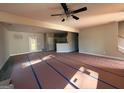Open-concept living room showcases stairs, ceiling fan, view of the kitchen, and a light fixture at 136 Asa Moseley Rd, Mcdonough, GA 30252