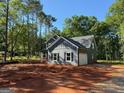 Exterior of the home showcasing a gray siding, white trim, and an attached garage at 148 Asa Moseley Rd, Mcdonough, GA 30252