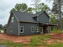 New two-story home featuring a gray exterior with a covered deck perfect for entertaining at 148 Asa Moseley Rd, Mcdonough, GA 30252