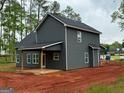 New two-story home featuring a gray exterior with a covered deck perfect for entertaining at 148 Asa Moseley Rd, Mcdonough, GA 30252