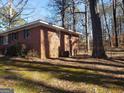 Brick house side view, showing a large yard at 9106 Woodhaven Nw Dr, Covington, GA 30014