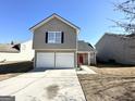 Two-story house with a two-car garage and red door at 270 Marriott Dr, South Fulton, GA 30349