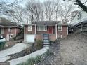 Charming brick home with red door and steps leading to the entrance at 211 Hemphill School Rd, Atlanta, GA 30331