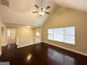 Spacious living room with hardwood floors, vaulted ceiling, and open staircase at 1134 Wagon Trce, Douglasville, GA 30134