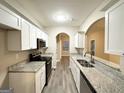 Modern kitchen with granite countertops and stainless steel appliances at 1024 Ada Nw Ave, Atlanta, GA 30318