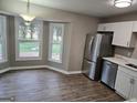 Bright dining area with bay window and wood-look flooring at 471 Glen Terrace Rd, Auburn, GA 30011