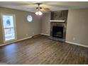 Spacious living room with stone fireplace and wood-look floors at 471 Glen Terrace Rd, Auburn, GA 30011