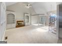 Bright living room with vaulted ceilings and a fireplace, awaiting your personal touches at 3905 Colonial Sw Trl, Lilburn, GA 30047