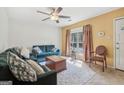 Bright living room with a large window and plush seating, featuring a stylish ceiling fan at 1144 Kipling Se St, Atlanta, GA 30315